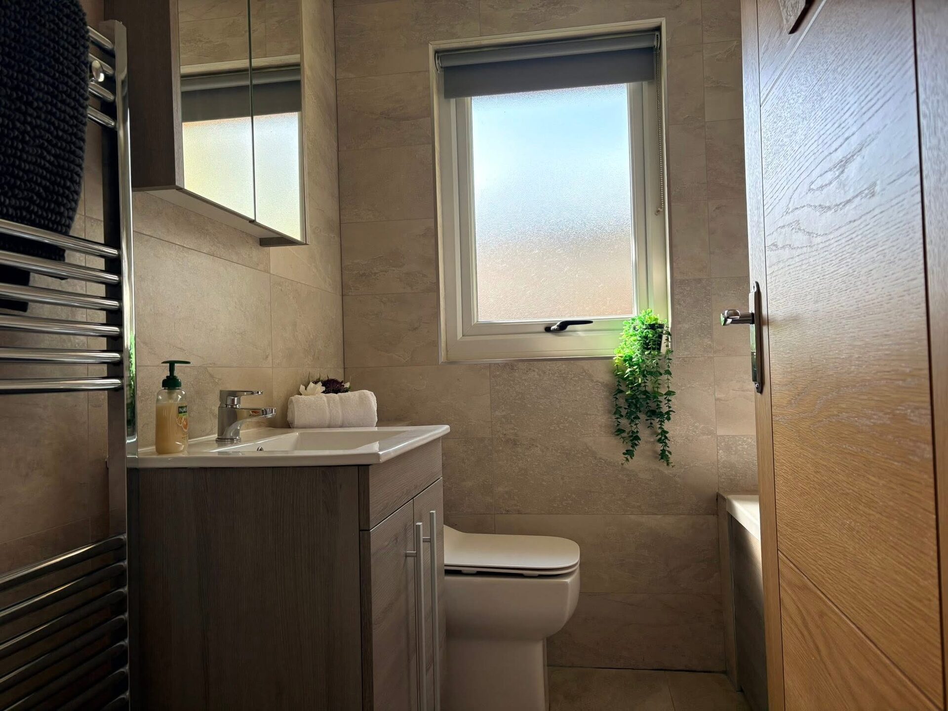 Bathroom with heated towel rail and window